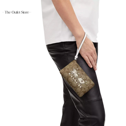 COACH CORNER ZIP WRISTLET IN SIGNATURE CANVAS WITH HORSE AND SLEIGH 